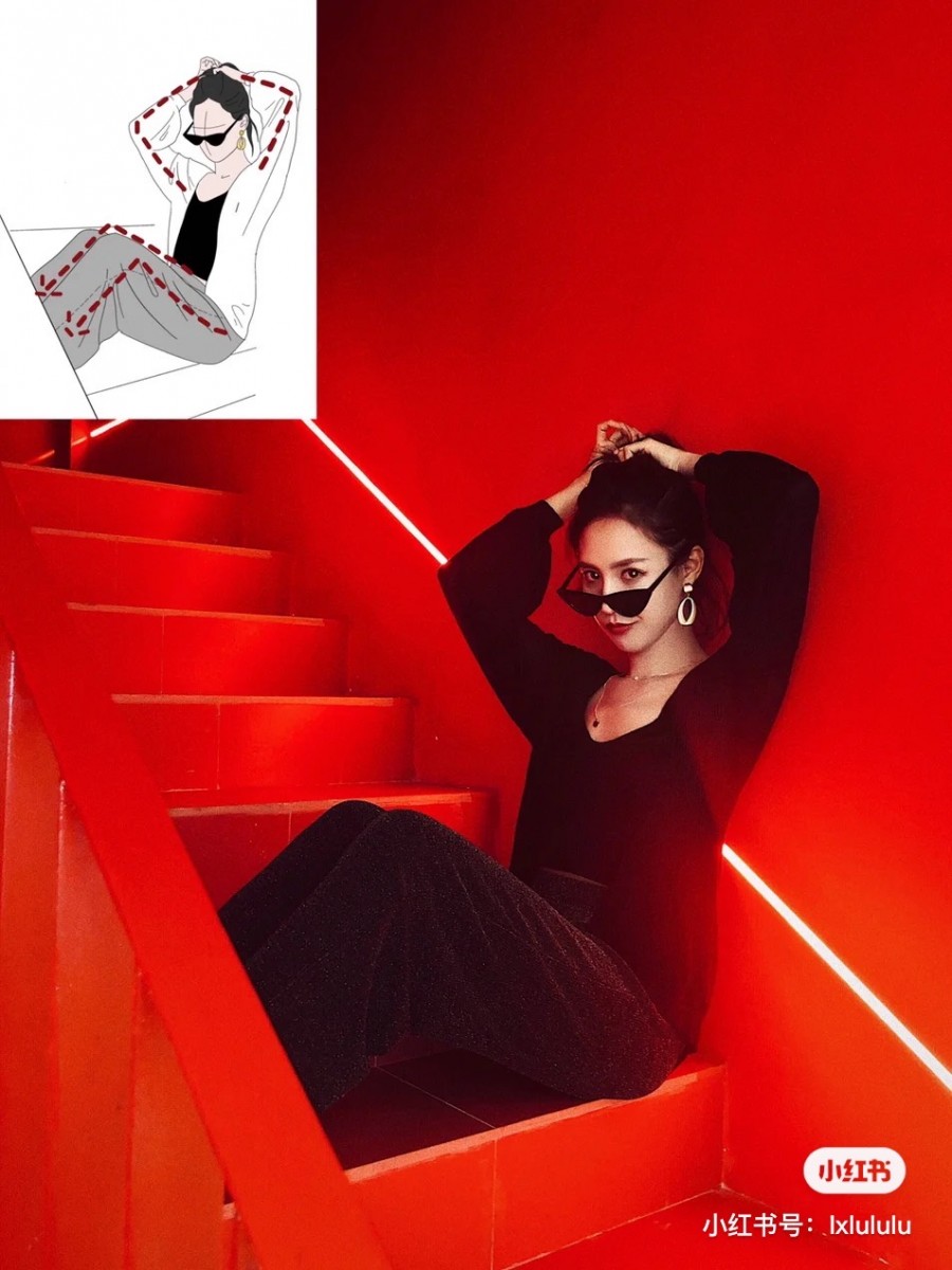 Girl sitting on the stairs sideways and touching her hair
