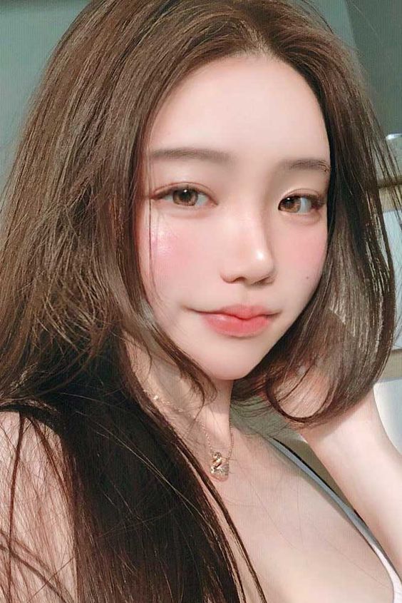 asian woman with pinky coral blusher To Get Fairer & Brighter Skin: