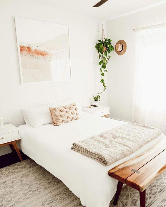 Guest bedroom with white walls and wooden furniture