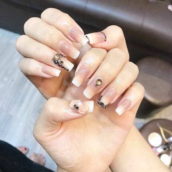 intricate nude Bridal Nail Art with black embellishments