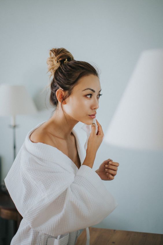 Girl applying essence using cotton pad