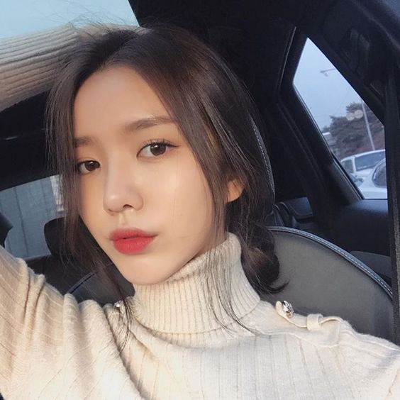 Girl with flawless complexion taking a selfie in the car