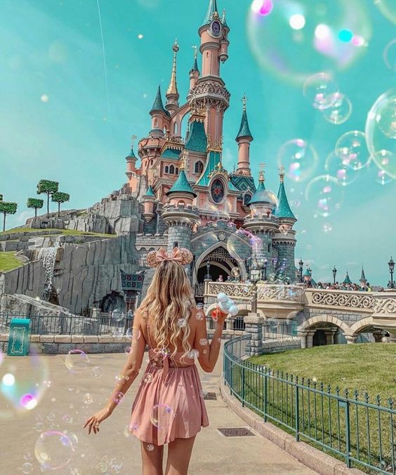 Girl walking to the castle in Disneyland