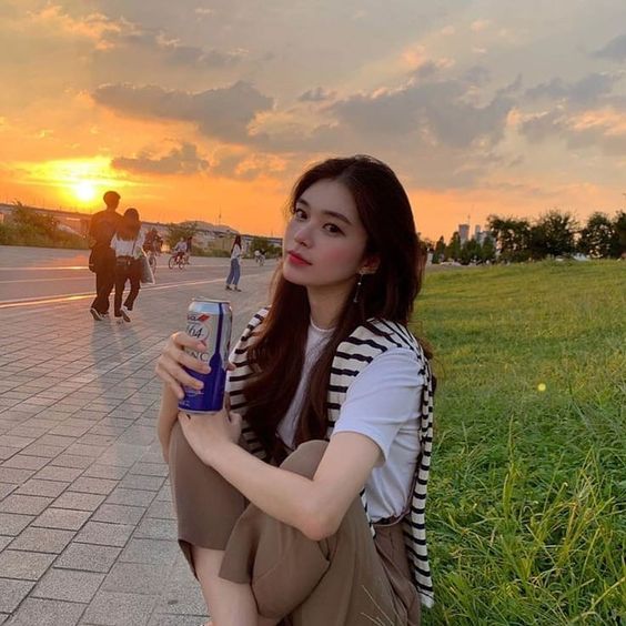 Girl drinking in a park