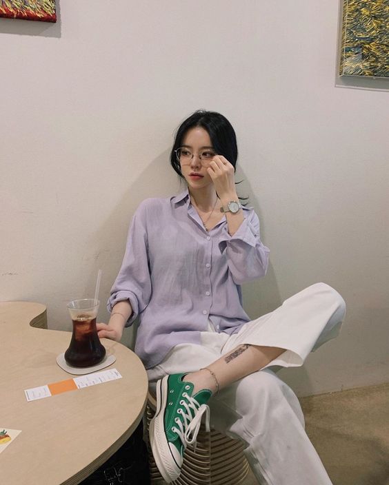 Girl sitting in a cafe with a cup of coffee on the table