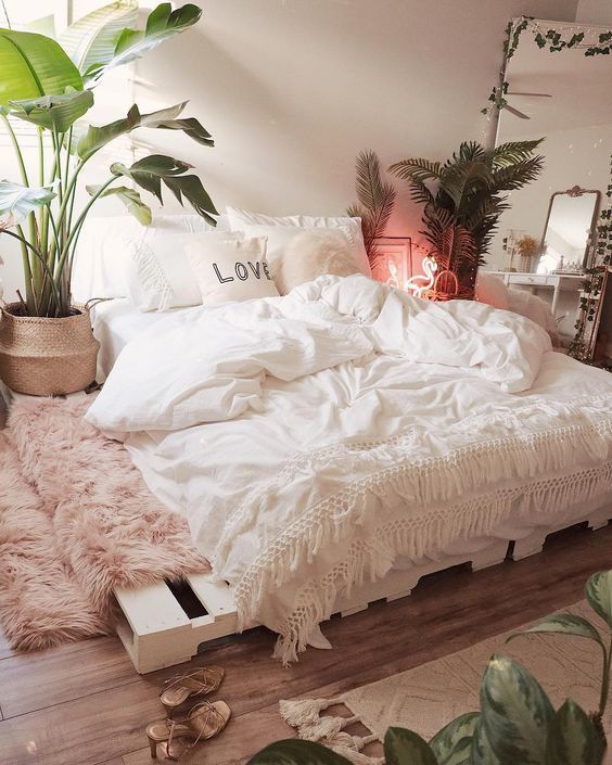 cosy pink and white bedroom with plants
