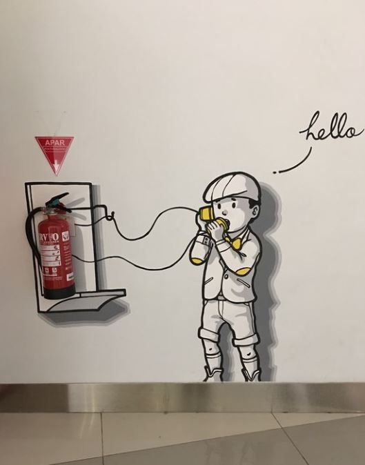 fire extinguisher with an illustration of a boy and the words hello
