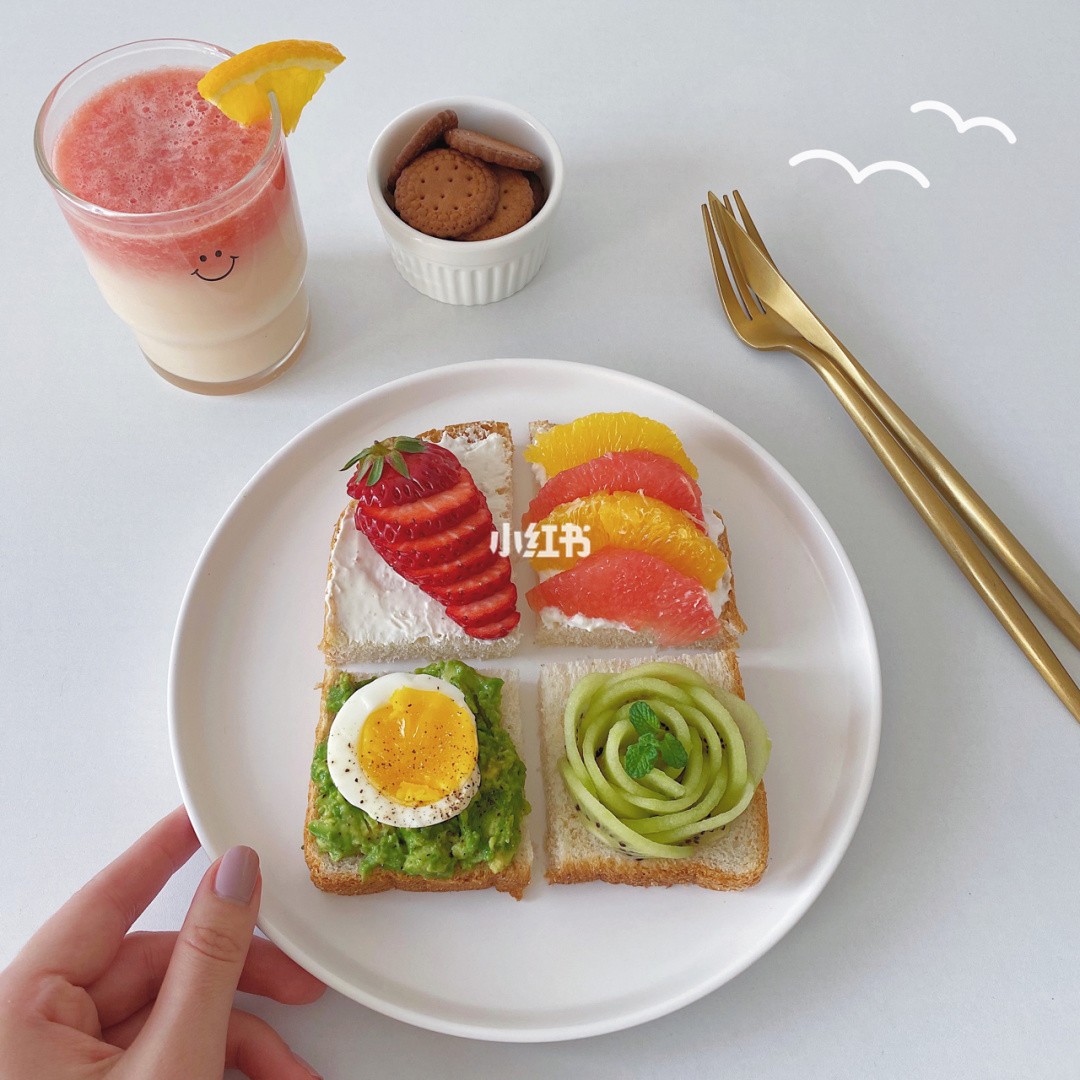Four mini toasts in one with strawberry, egg, avocado, grapefruit, orange, kiwi and cream cheese