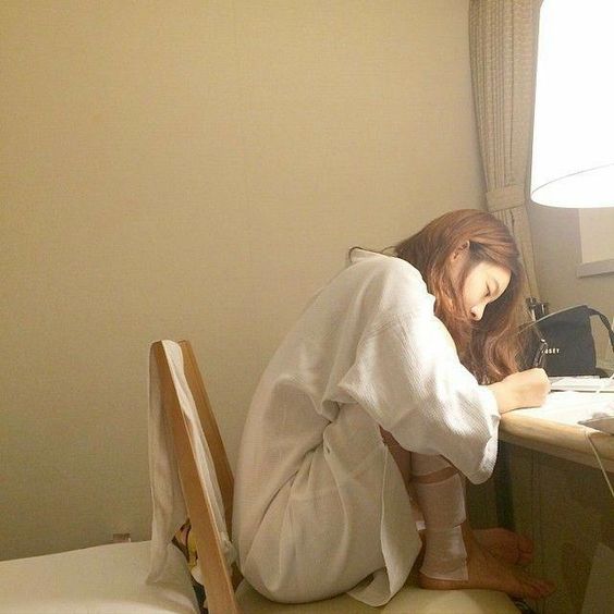 asian girl at home writing a letter