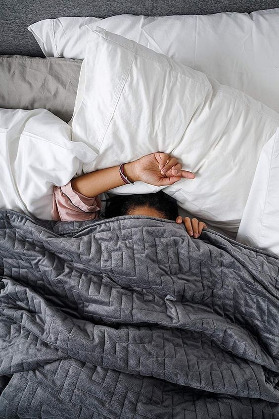 Woman sleeping under a blanket 