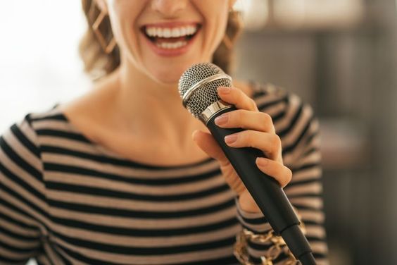 Woman singing karaoke at home