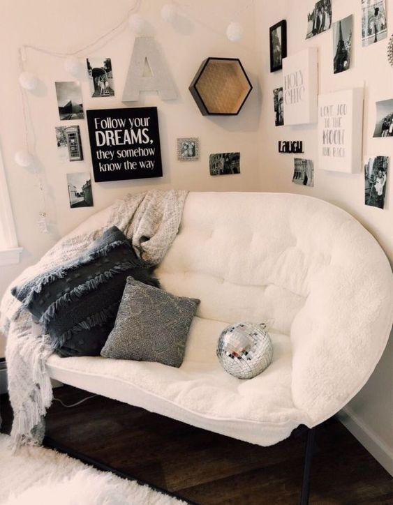 cosy reading nook with white, black and grey colour scheme, pillows, blankets with art gallery display