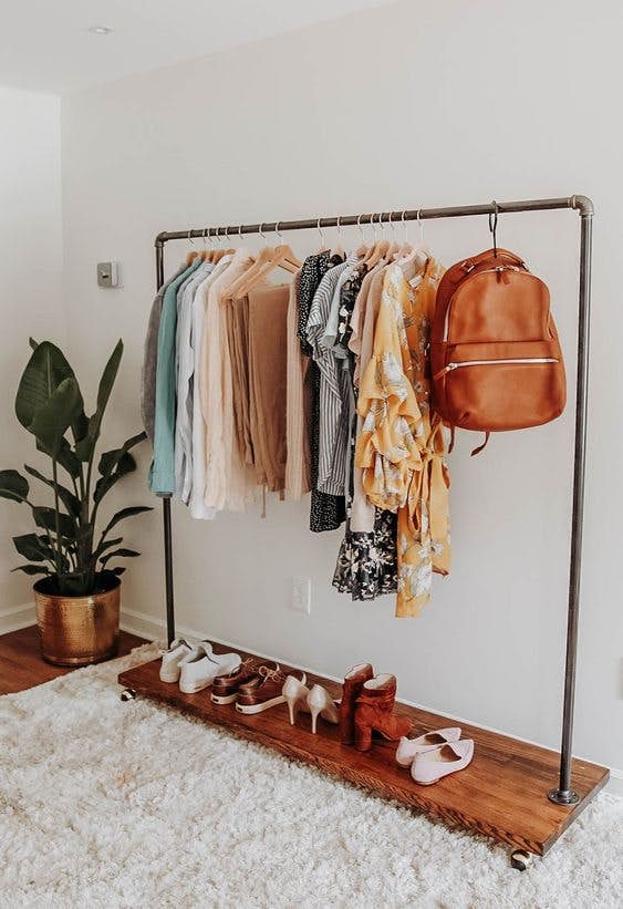 open wardrobe with bright summer clothes and shoes