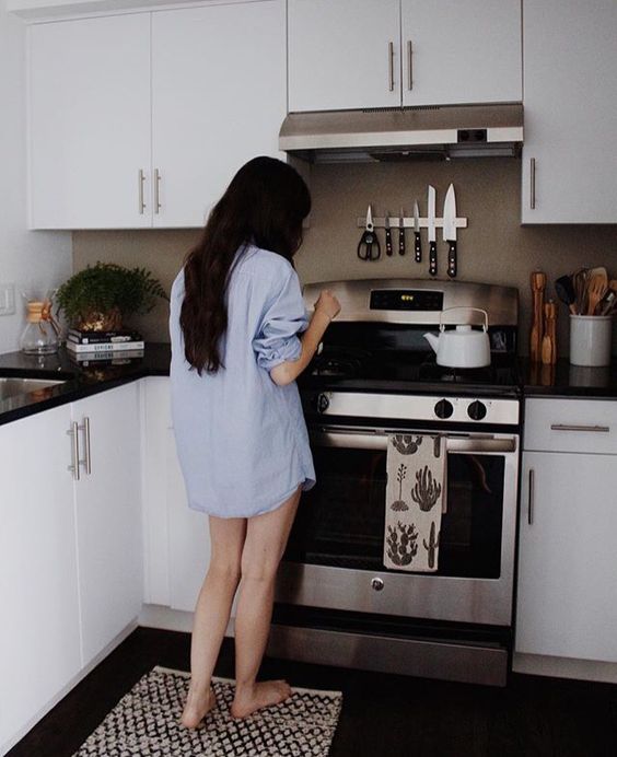 Girl in her kitchen cleaning up