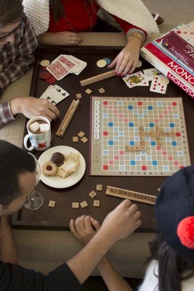 family playing board game with snacks