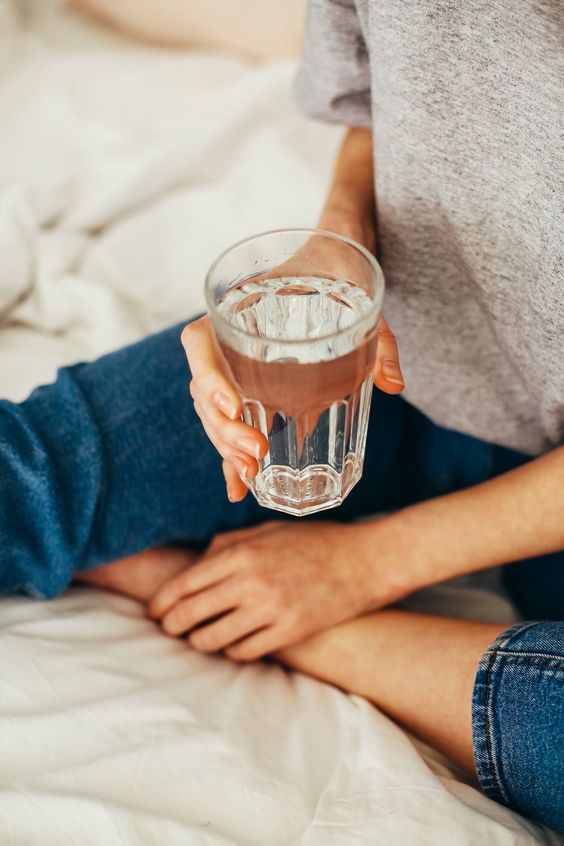 Girl holding a glass of water