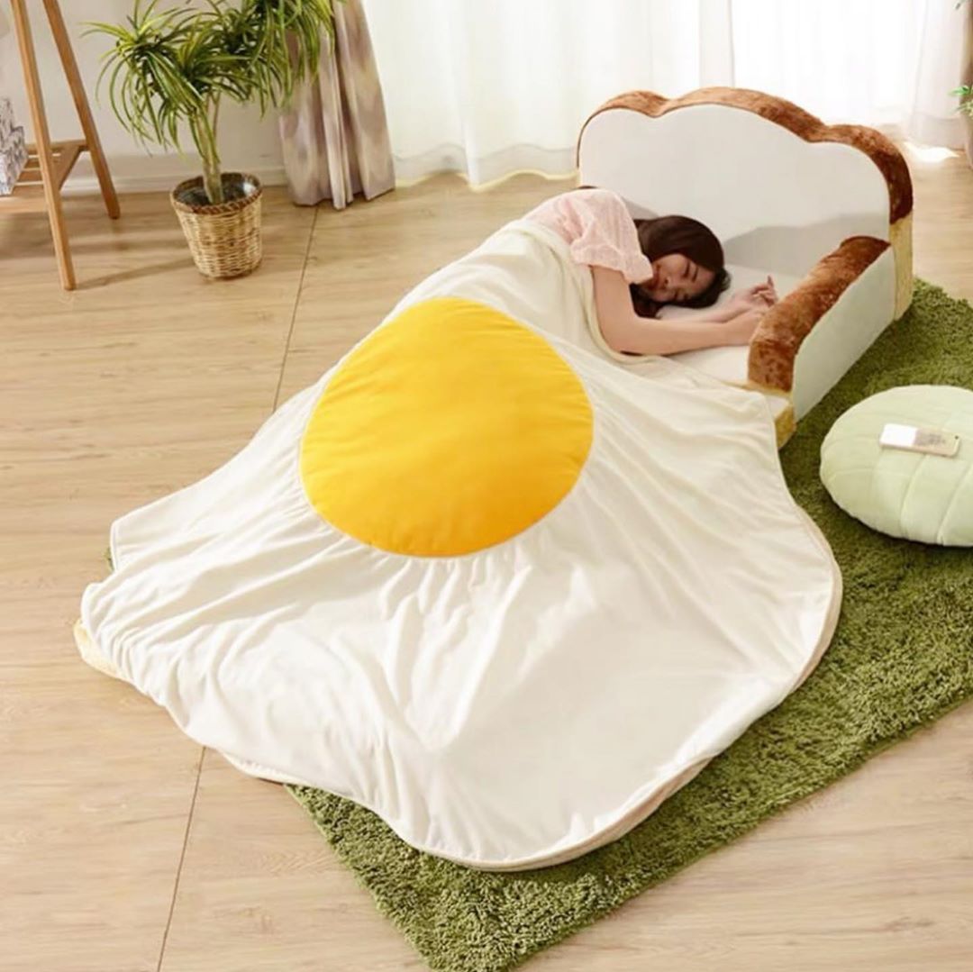 girl lying on bread pillow with an egg blanket