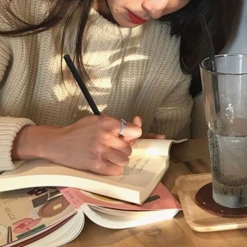 Girl writing things down in a book