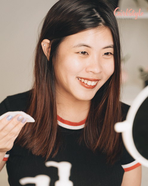 asian woman removing eye makeup with cotton pad and micellar water