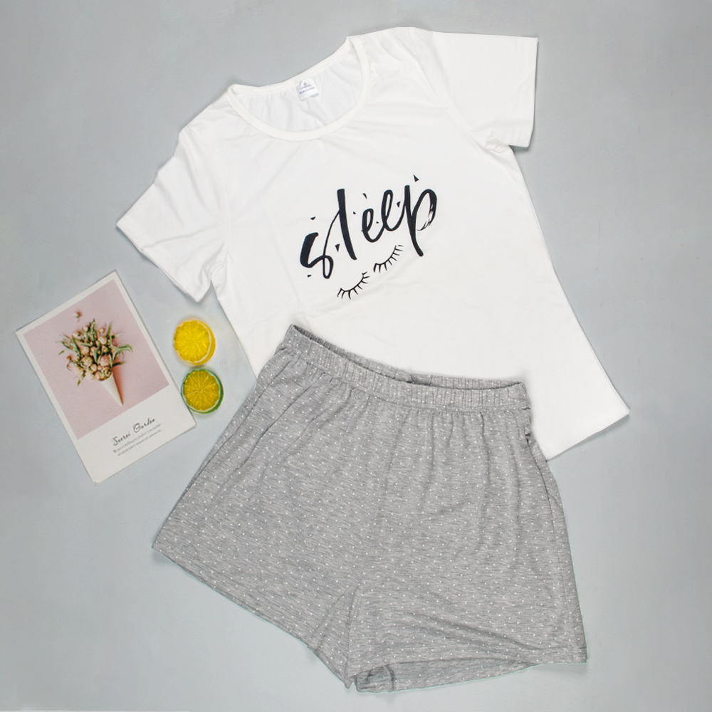 grey and white pyjamas with the word 'sleep' and a pair of eyelashes