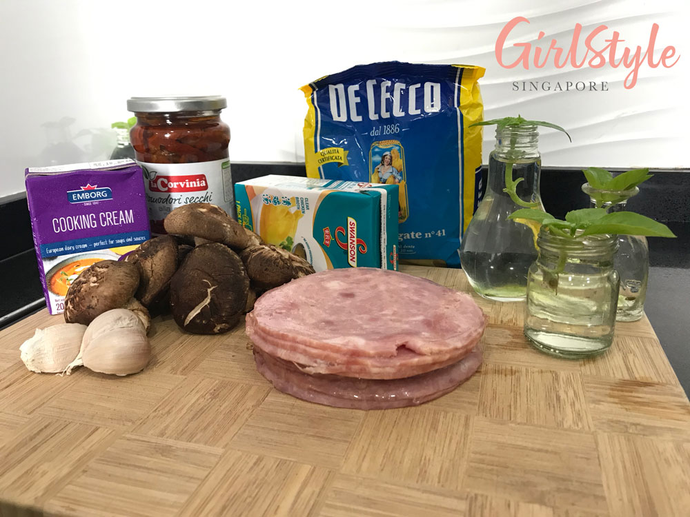 ingredients for homemade Alfredo penne pasta ham, cooking cream, mushrooms