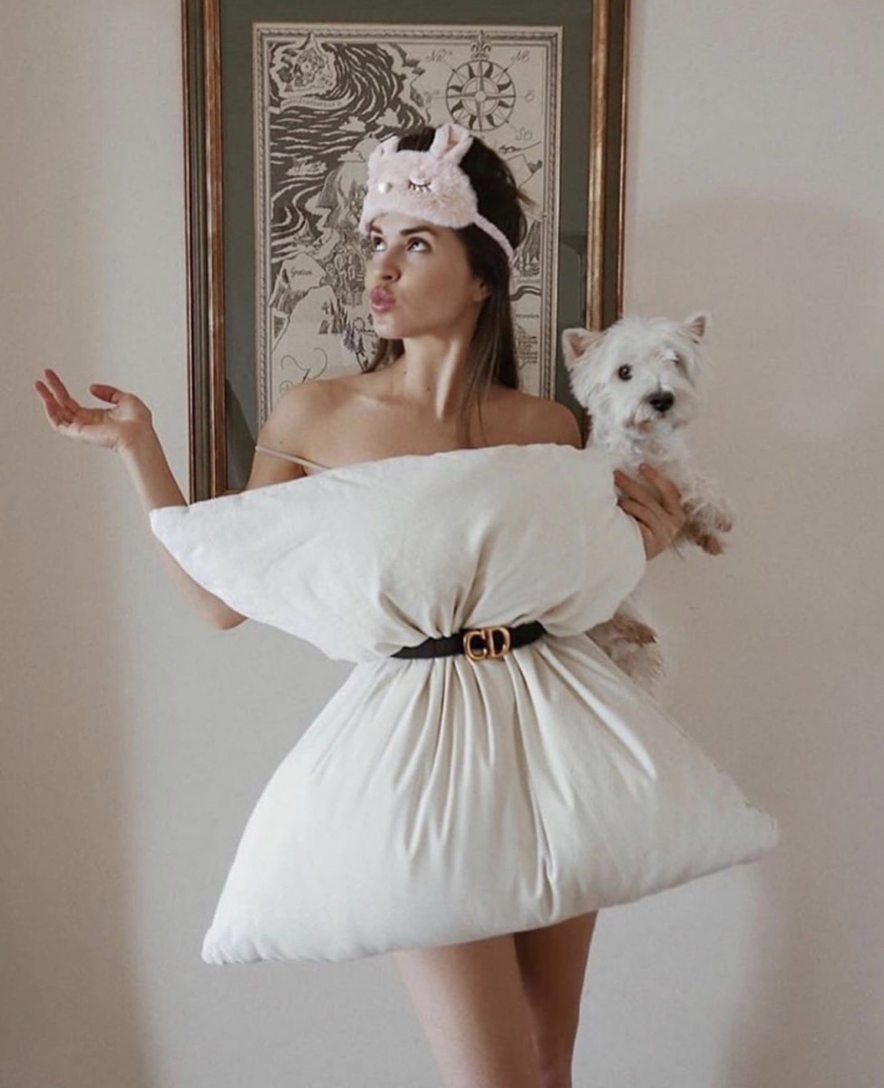 Lady with pillow holding a dog 