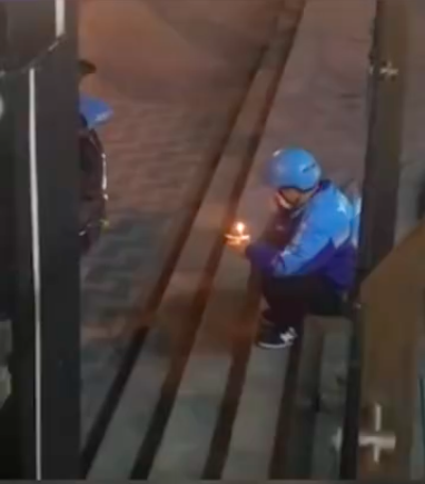 delivery man in china sitting on steps with birthday cake