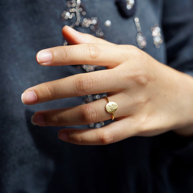 woman's hand with a Birth flower ring