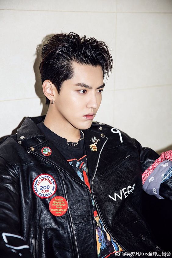 kris wu side profile wearing black jacket with pins