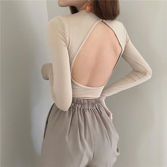 asian woman wearing a nude backless top and grey shorts
