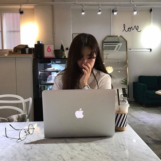 Girl sitting in the cafe using her laptop