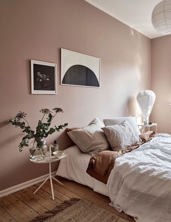 bedroom with pink walls and a plant