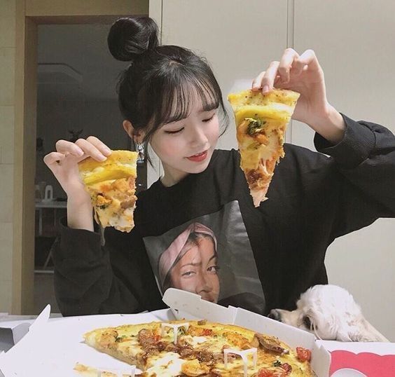Girl eating pizza at home