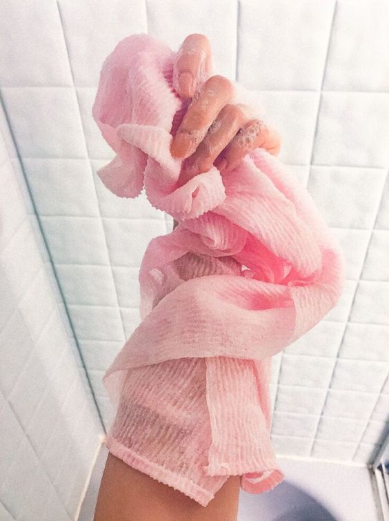 Using a loofah to exfoliate during a bath
