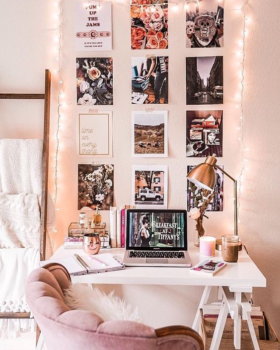 cosy reading nook with grey colour scheme, pillows, blankets, table, and art display