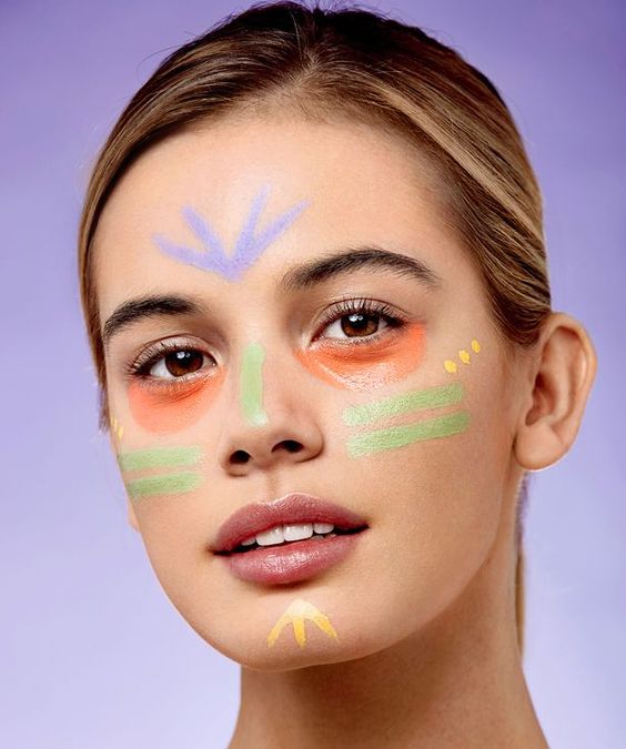 Girl with different colour correctors applied on her face