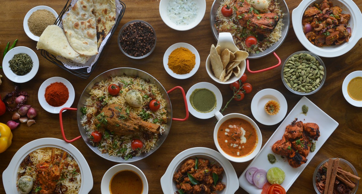 indian food including curry and Hyderabadi Dhum Biryani