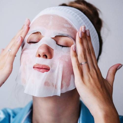Asian Lady Applying Mask