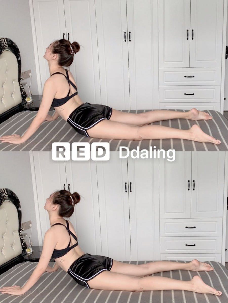 asian woman doing abdomen stretches on a bed