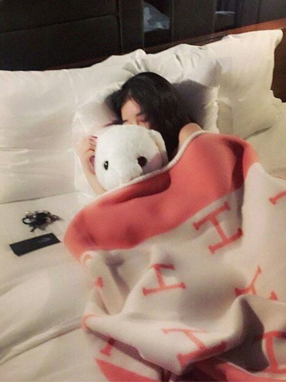 Girl sleeping and hugging soft toy