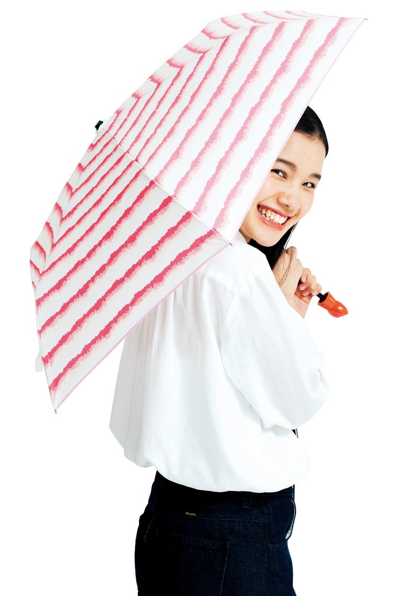 YOU+MORE! shrimp tempura umbrella opened up and a woman carrying it