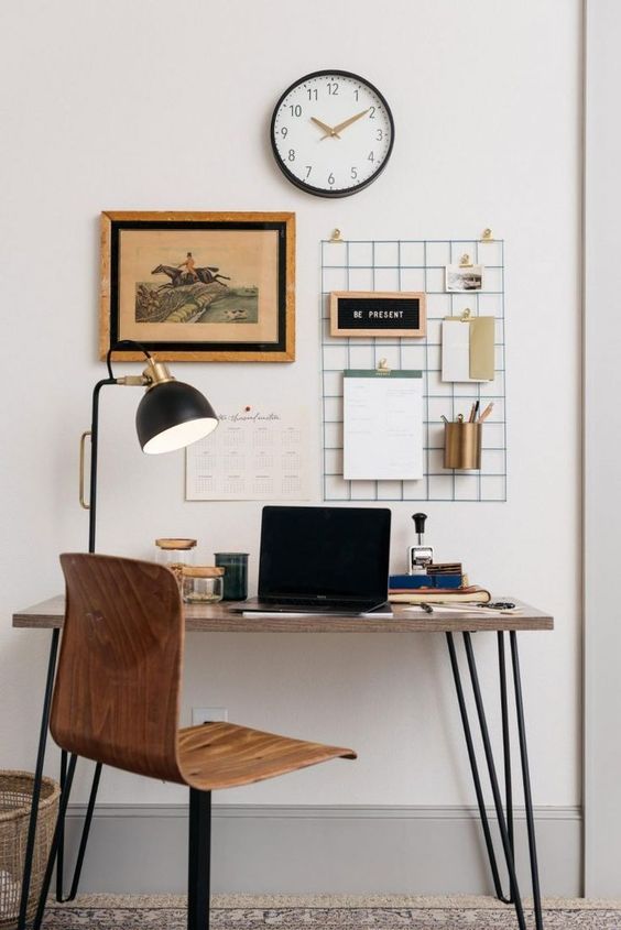 home office with wired display hanging on the wall and a lamp