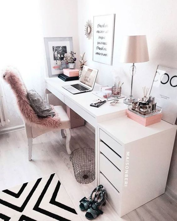 pink and white home office with quotes on walls and furry throw