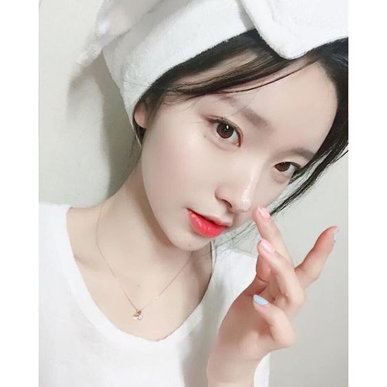 Girl applying skincare products