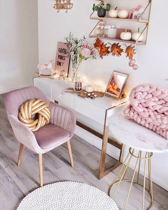 pink and white home office with fairy lights and autumn leaves