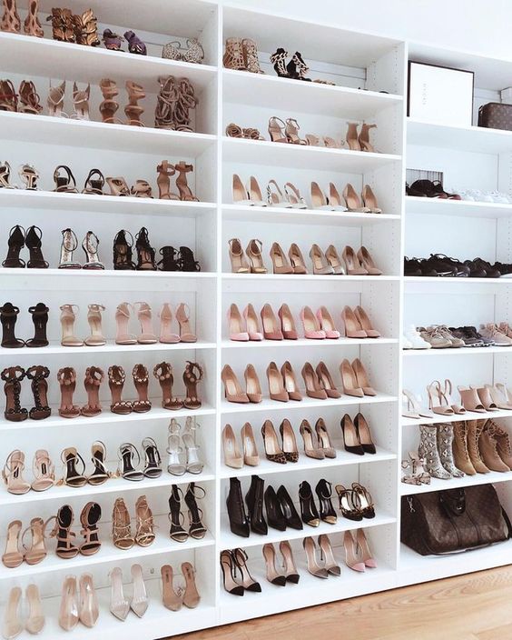 large shoe closet collection on white shelves