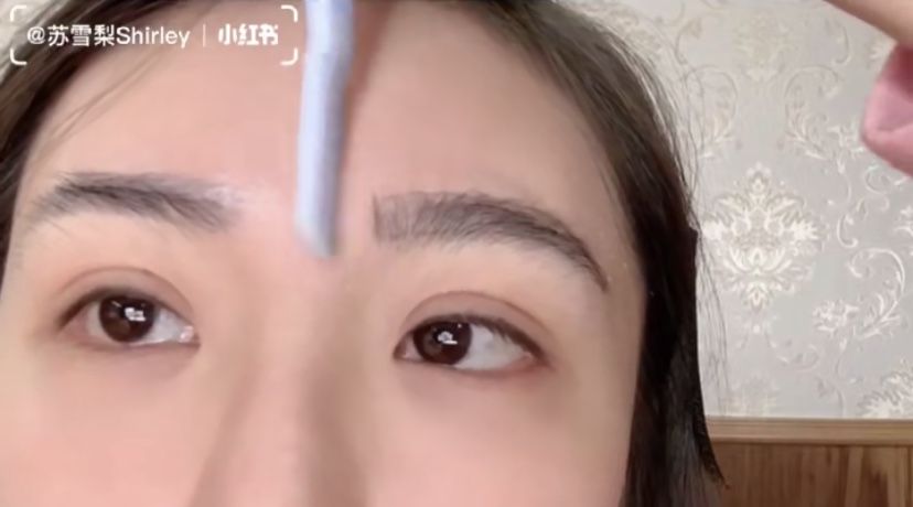 Asian Girl Trimming Eyebrows
