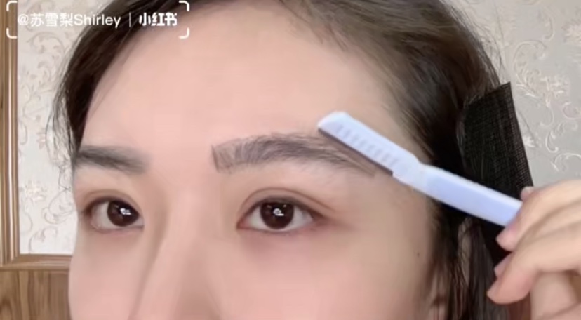 Asian Girl Trimming Eyebrows