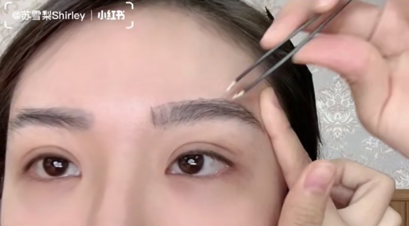 Asian Girl Trimming Eyebrows