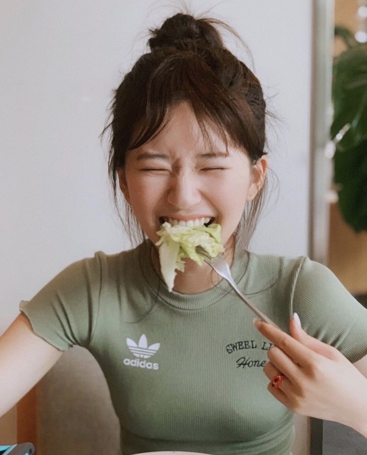 Asian Lady Eating Vegetables